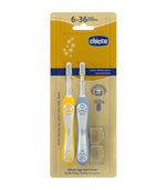 Chicco two-pack toddler toothbrushes with mustard yellow and pale blue handles, ages 6–36 months