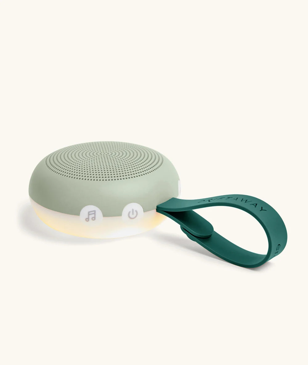 Close-up of Drift Away white noise machine power button and strap