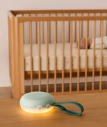 Sage Drift Away machine glowing beside a cot