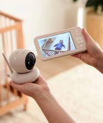 Parent holding Drift Home monitor and camera